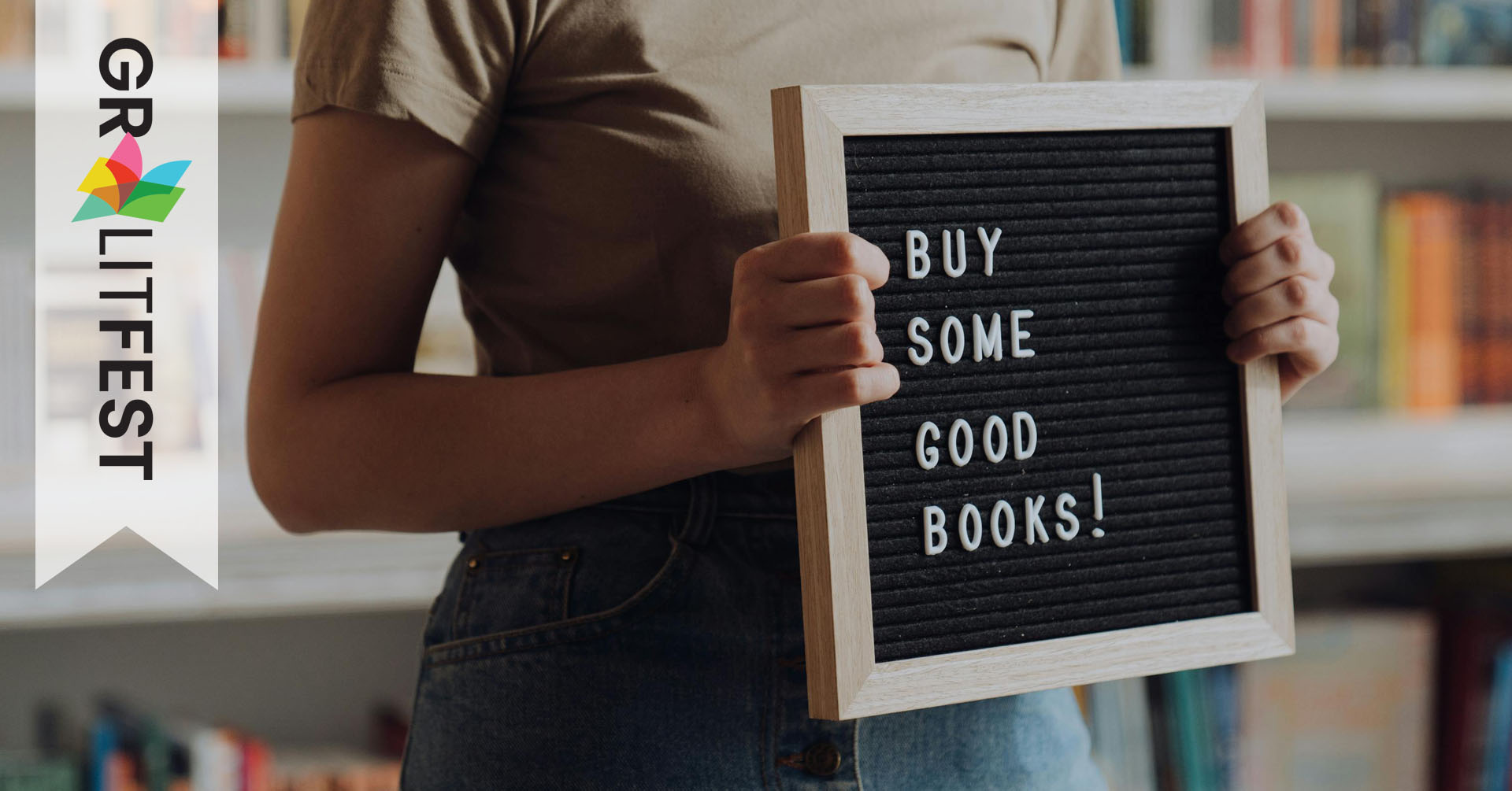 woman holding sign reading Buy Good Books