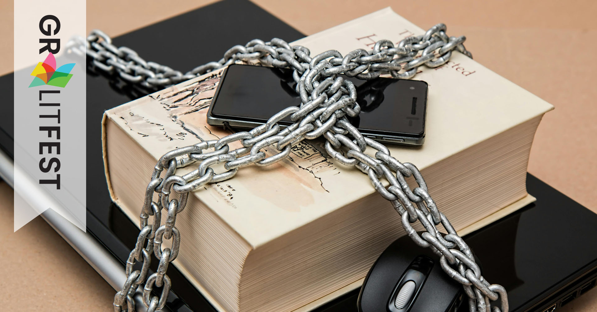 laptop phone and book in chains